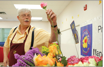 Florist shows students how to arrange bouquets